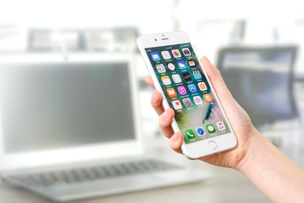 a cellphone, a woman is carrying a white iphone