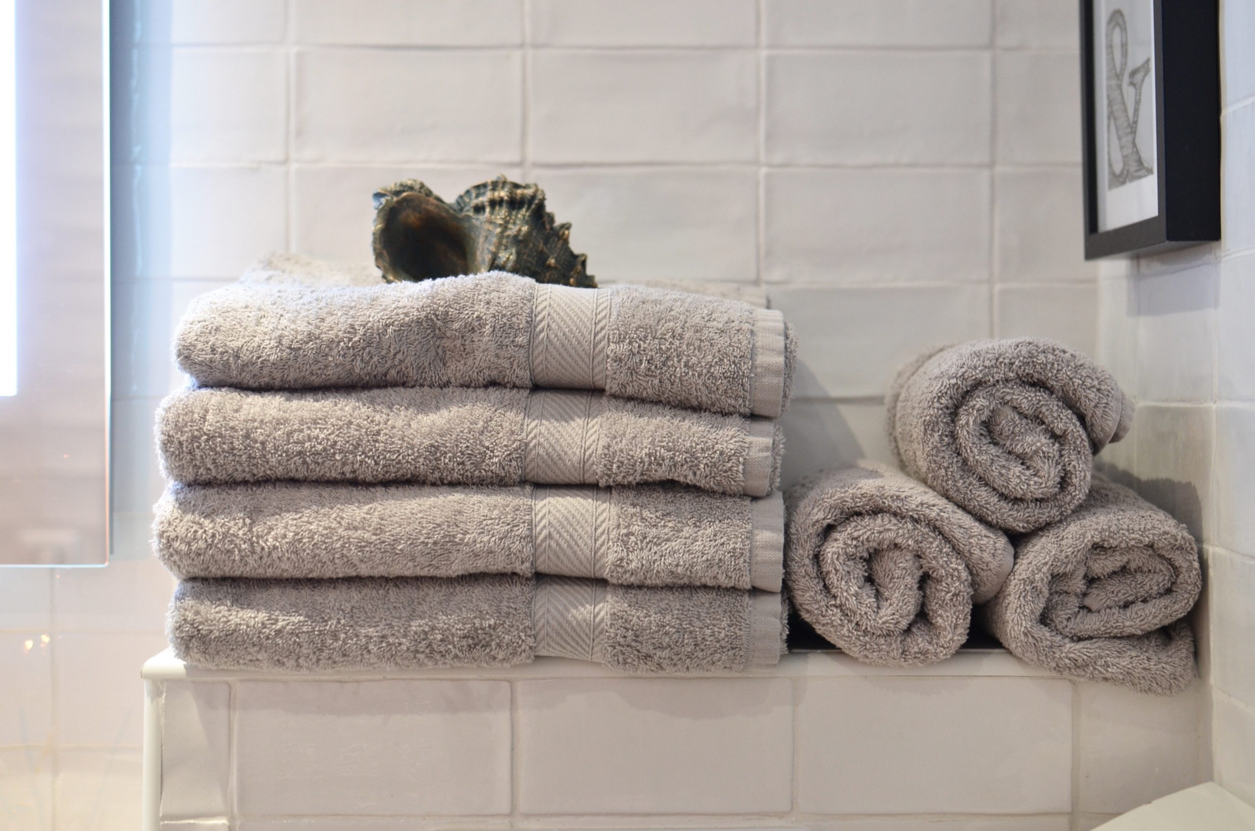 a towel, gray towels on a ceramic shelf