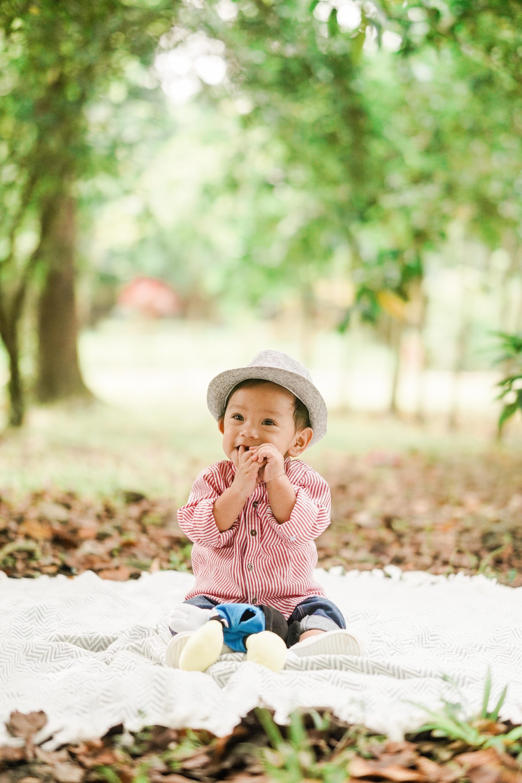 ha baby sitting on a white sheet in the forest, ow to shop for baby clothes