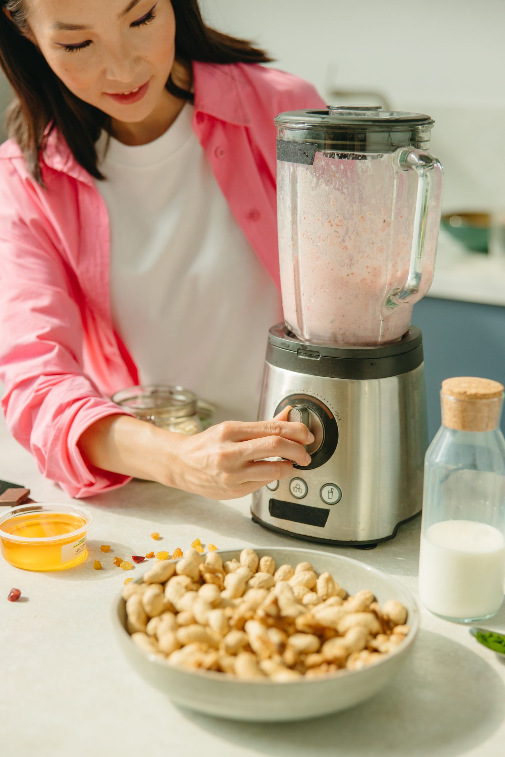 a woman making cooktail with a blender, how to shop for a blender