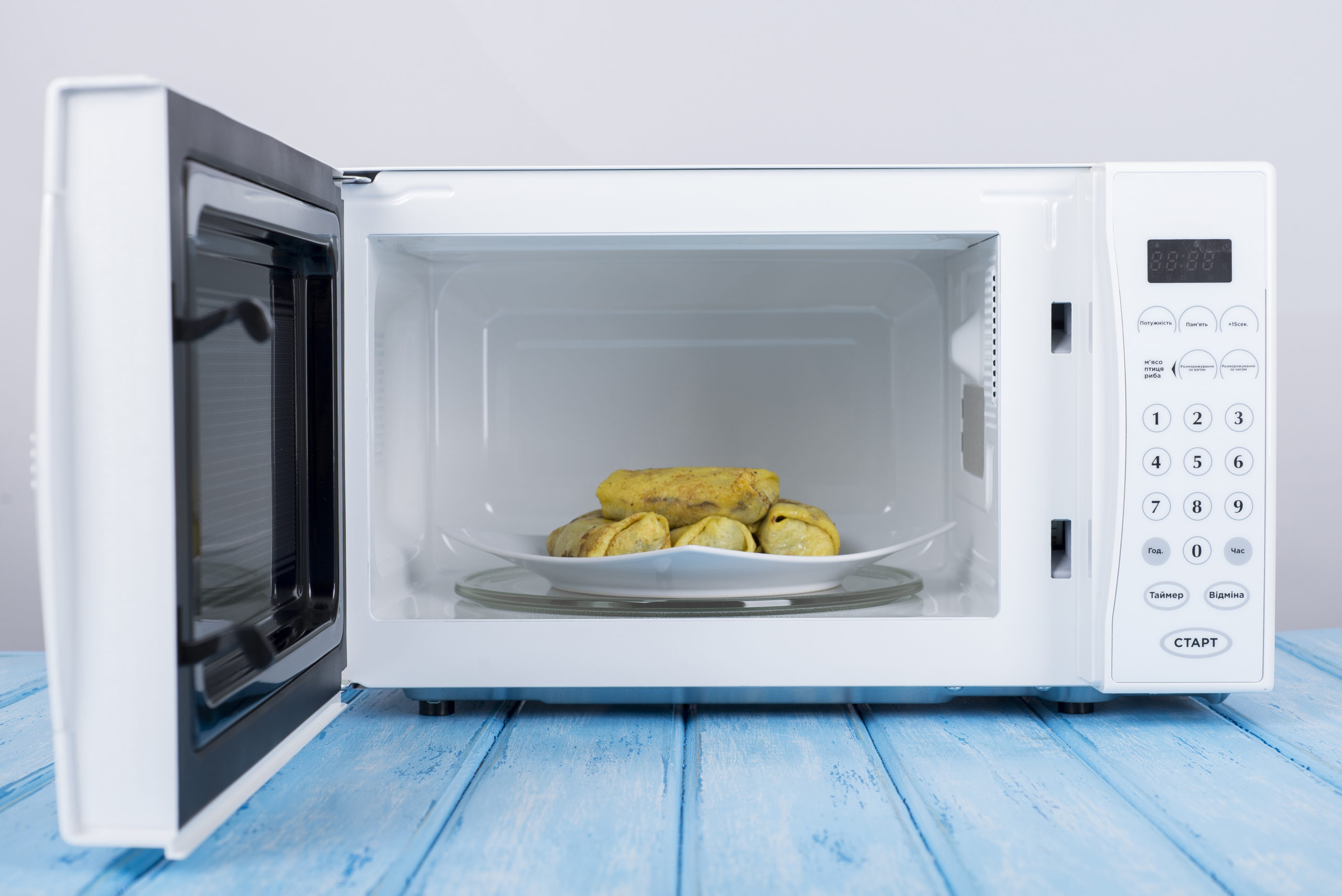 microwaves, a white microwave with food inside it, how to shop for a microwave