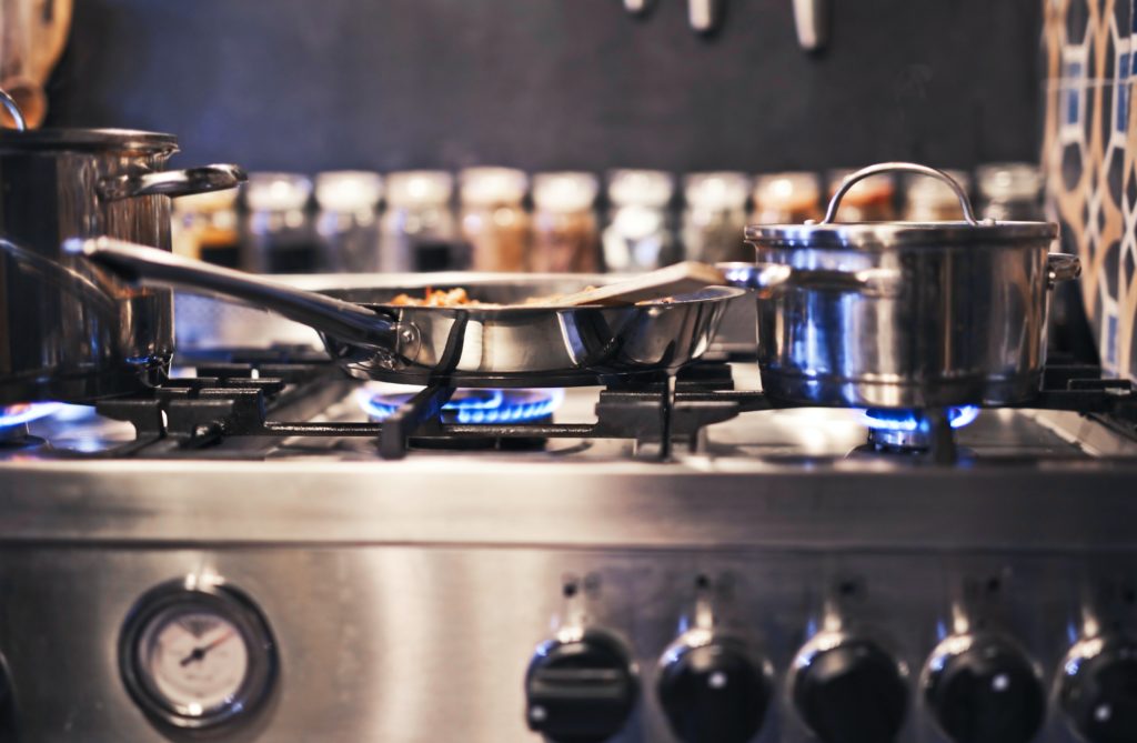 a stainless steel fryer and cooking pot on a stainless steel stove, how to shop for a stove