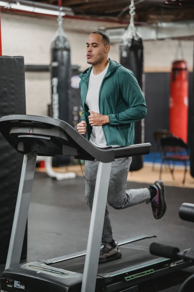 a man is running on the treadmill, how to shop for a tredmill