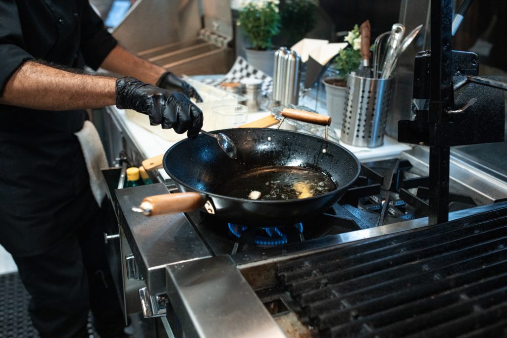 how to clean the cookhardware, a man frying food in a fryer pan